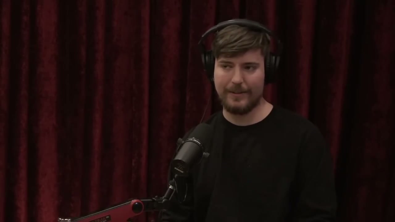 화면 옆에서 손짓을 더해 알고리즘의 비선형 보상을 설명하는 MrBeast